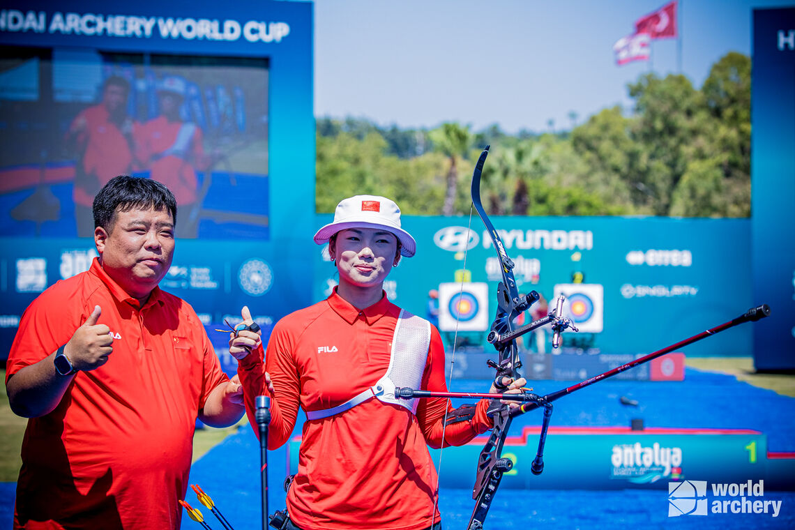 Yang Xiaolei and coach Kwon Yonghak celebrating.