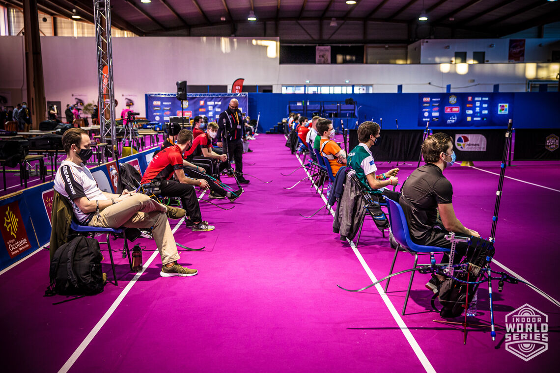 Archers wait on their spaced chairs during qualification at the Sud de France – Nimes Archery Tournament in 2021.