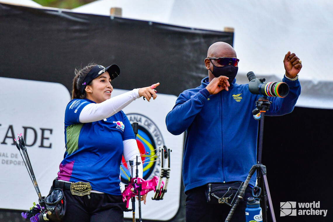 Sara Lopez discusses the wind with her coach during finals at the Pan American Championships in 2021.