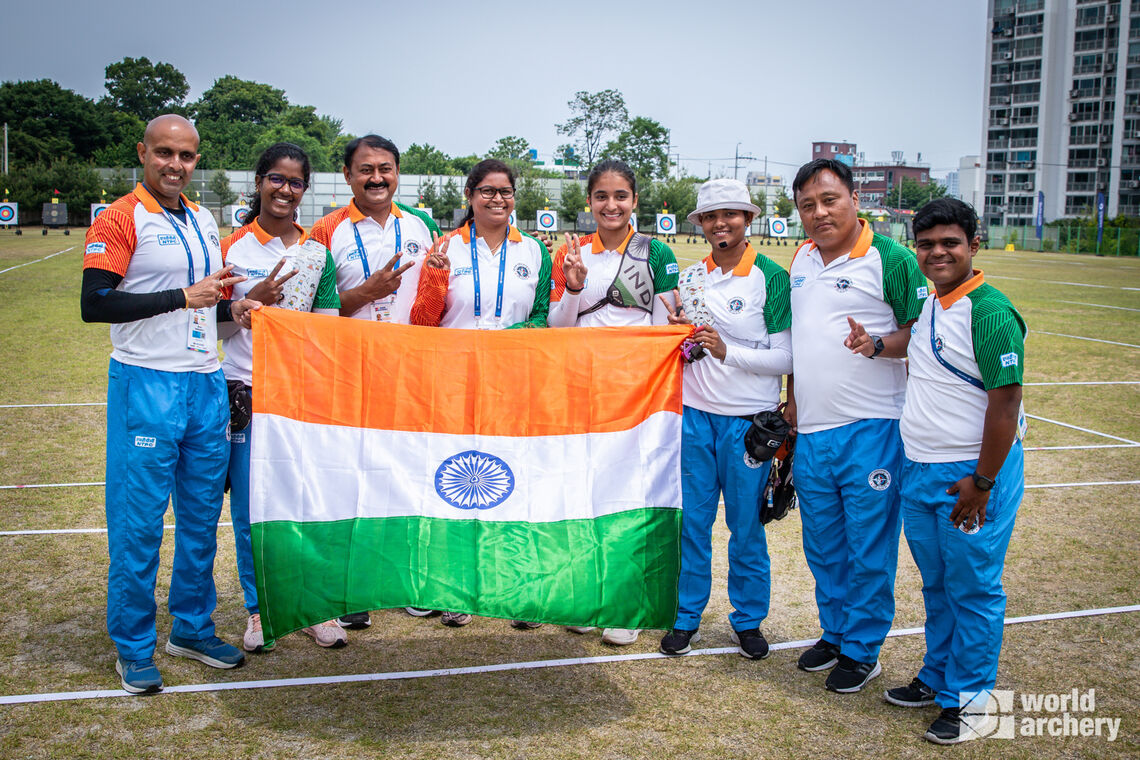 The Indian team celebrates an early bronze medal in Korea.