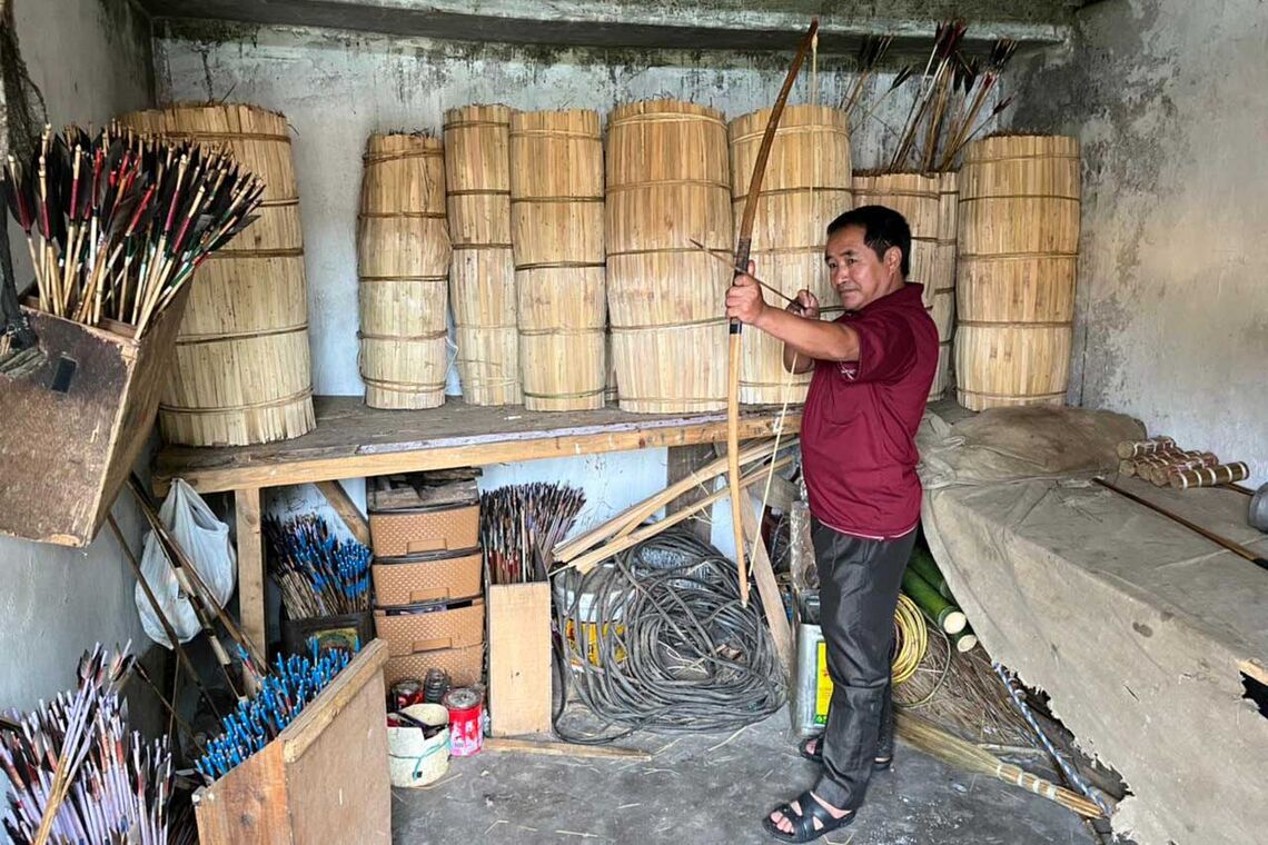 Teer game official showing the storage room for bows and arrows. 