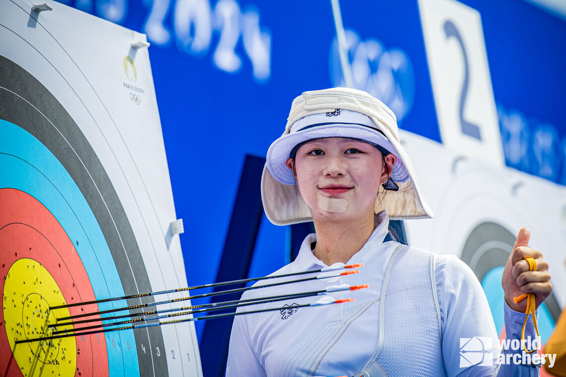 Lim Sihyeon poses with her last six arrows of qualifying in the target.