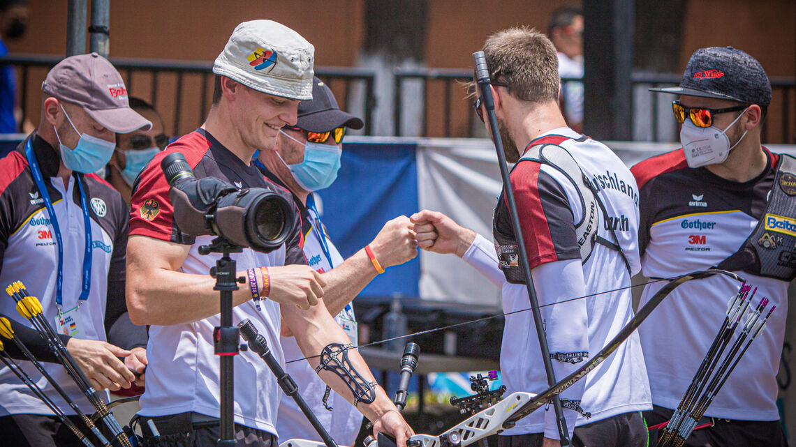 The German recurve men’s team bump fists during the bronze medal match.