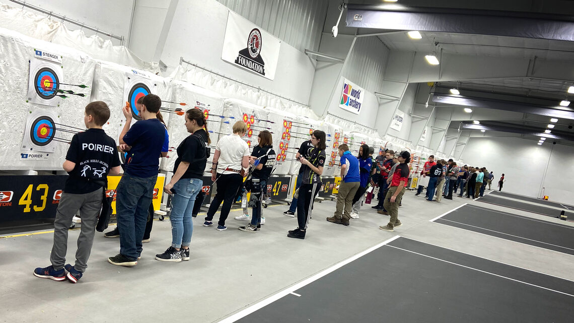 Youth archers scoring at the targets at the Rushmore Rumble in 2020.
