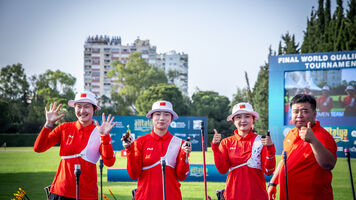 China recurve women’s team celebrating with coach.
